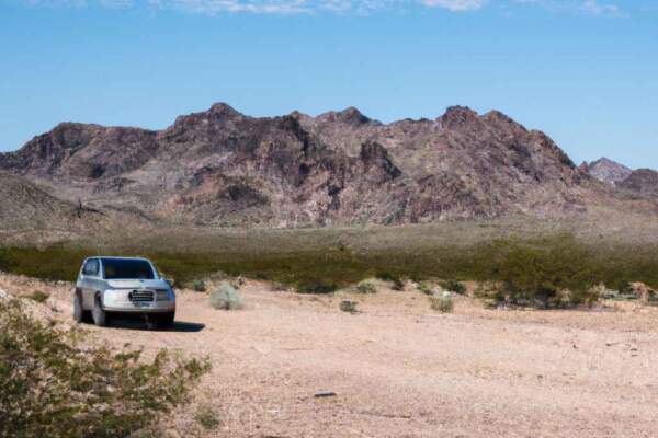 Car parked on an open highway through the Southwest desert